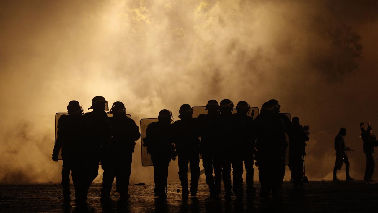 Riot police officers take position near the Arc de Triomphe. Picture: AP