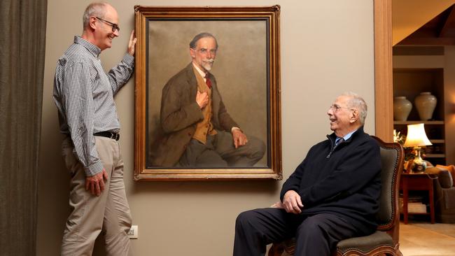 Clive Smith with WB McInnes’s winning portrait of his grandfather, Julian Smith, and his cousin, also Julian Smith. Picture: David Geraghty