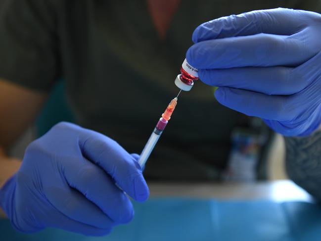 SYDNEY, AUSTRALIA - NewsWire Photos FEBRUARY, 19, 2021: A pharmacist demonstrates the filling of syringes ahead of the Covid-19 vaccine rollout at the USYD Brain and Mind Centre at Camperdown in Sydney. Picture: NCA NewsWire/Joel Carrett