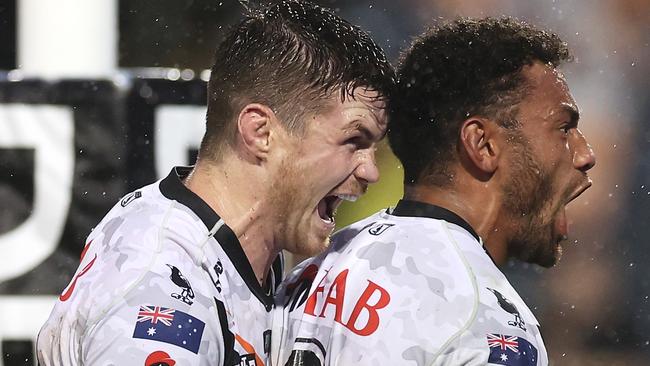 John Bateman and Apisai Koroisau of the Wests Tigers celebrate Koroisau scoring a try during the round eight NRL match at Campbelltown Stadium on April 23, 2023. Picture: Mark Kolbe/Getty Images