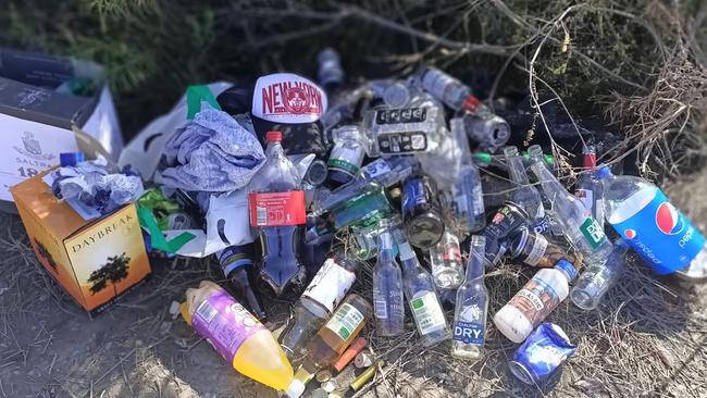 Empty alcohol containers, rubbish and discarded clothing were left behind after a weekend, late night, full moon party at the environmentally-sensitive Old Quarry Swamp on Sydney's North Head. Picture: Ronia Bourke