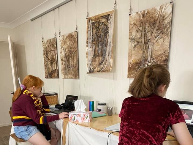 Two of Rockhampton artist Emma Ward's daughters - Honey and Evie - have set up their home school in Emma's art studio.