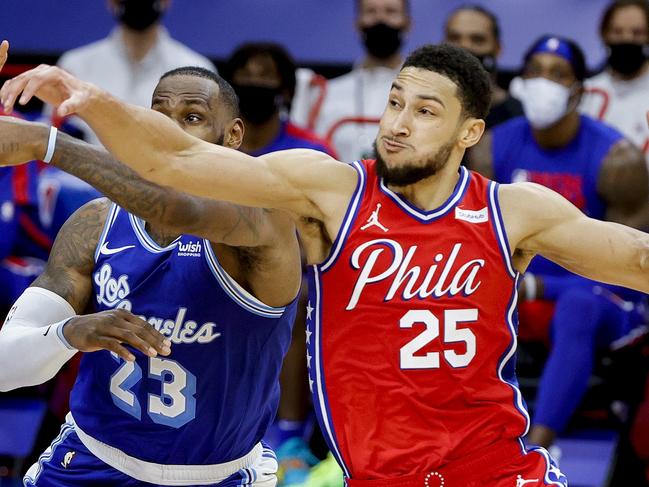 PHILADELPHIA, PENNSYLVANIA - JANUARY 27: LeBron James #23 of the Los Angeles Lakers, and Tobias Harris #12 and Ben Simmons #25 of the Philadelphia 76ers reach for the ball during the fourth quarter at Wells Fargo Center on January 27, 2021 in Philadelphia, Pennsylvania. NOTE TO USER: User expressly acknowledges and agrees that, by downloading and or using this photograph, User is consenting to the terms and conditions of the Getty Images License Agreement.   Tim Nwachukwu/Getty Images/AFP == FOR NEWSPAPERS, INTERNET, TELCOS & TELEVISION USE ONLY ==