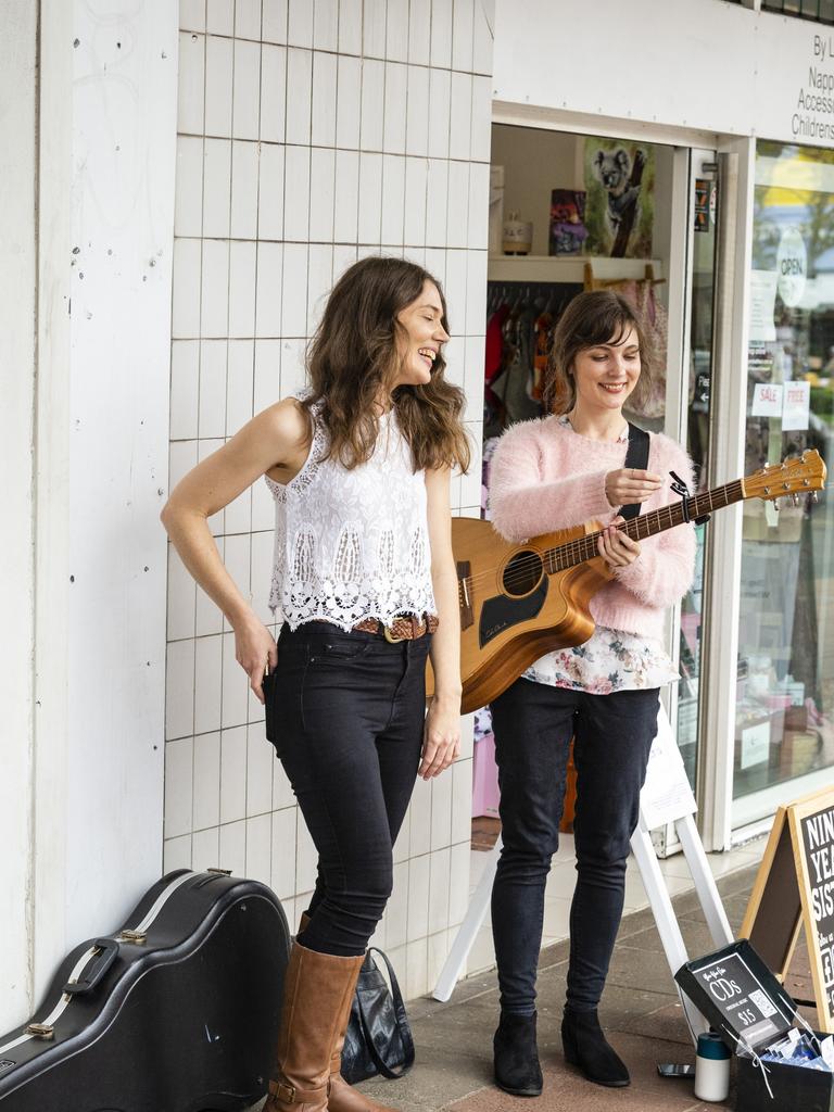 Jennie (left) and Emma Wardle wrap up their performance as Nine Year Sister in the Toowoomba Busking Festival, Saturday, April 30, 2022. Picture: Kevin Farmer