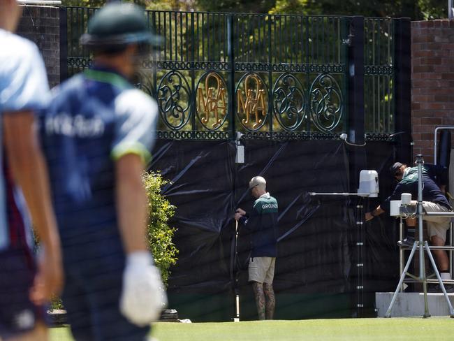 Workers block out the gates at the request of India for their practice on Thursday. Picture: Sam Ruttyn