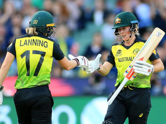 Beth Mooney celebrates her half-century with captain Meg Lanning at the crease during the 2020 ICC Women's T20 World Cup final at the MCG between Australia and India. Picture: Mark Stewart