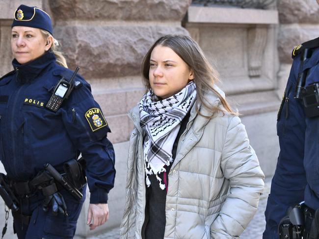 Swedish climate activist Greta Thunberg (C) is led away by police after being arrested during a sit in outside the Swedish parliament, the Riksdagen, to demonstrate for climate action, on March 12, 2024 in Stockholm, Sweden. Picture: Samuel Steen/TT News Agency/AFP/