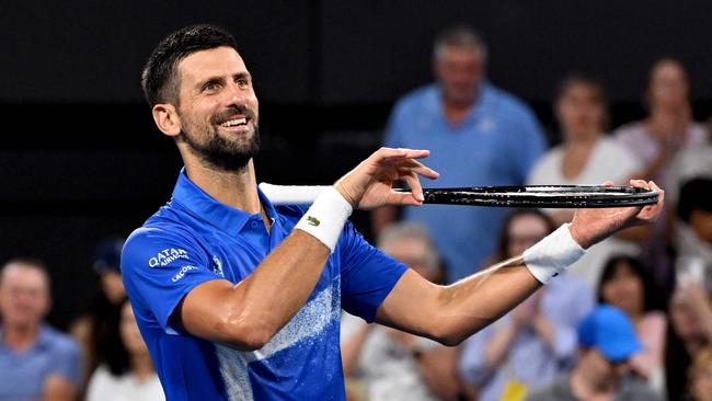 Novak Djokovic of Serbia pretends to play the violon after winning his men's singles match against Gael Monfils of France at the Brisbane International tennis tournament in Brisbane on January 2, 2025. (Photo by William WEST / AFP) / --IMAGE RESTRICTED TO EDITORIAL USE - STRICTLY NO COMMERCIAL USE--