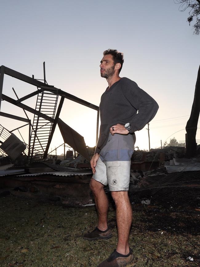 Shannon Williams stands among the gutted buildings in Tathra. Picture: Gary Ramage