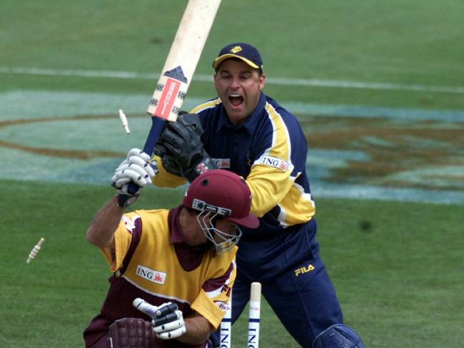 Victorian wicketkeeper Darren Berry stumps Queensland batsmman Jimmy Maher in an ING Cup one day match at Punt Road in October 2001.