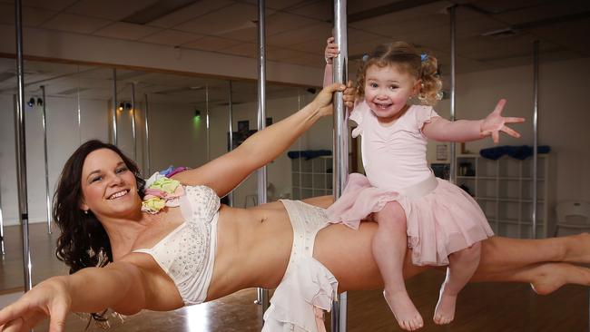 Regional Pole Artistry Championships judge and International Pole Artistry competitor Kristy Sellars with her daughter Rylie 2. who has started to join in while watching mum at work teaching at Physipole Studios in Ballarat. Rylie 2, joins mum Kristy up the pole balancing on her mum's legs. Picture: David Caird.