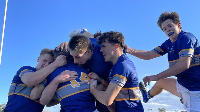 Churchie's Mac Kelley is swamped after scoring.