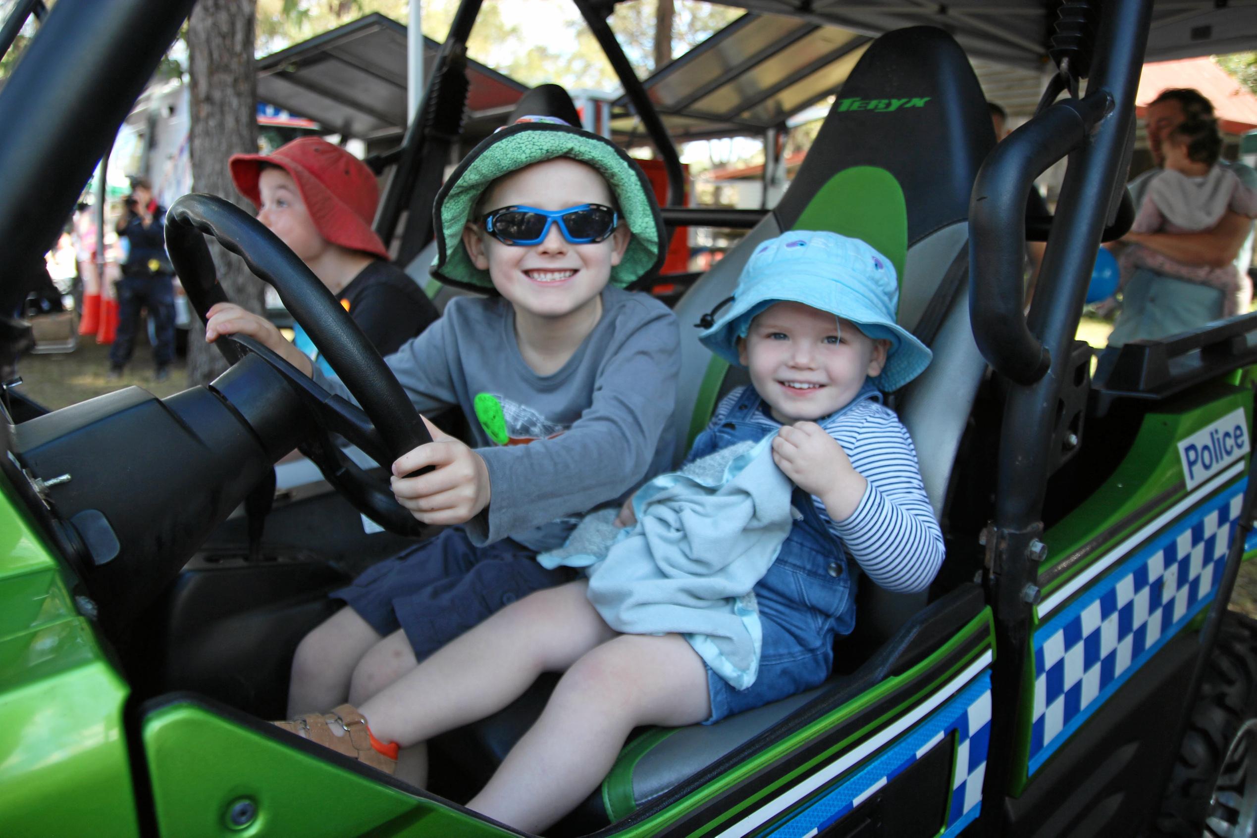 Liam and Lachlan Studholme enjoying their ride on a Queensland Police Service buggy. Picture: Shayla Bulloch