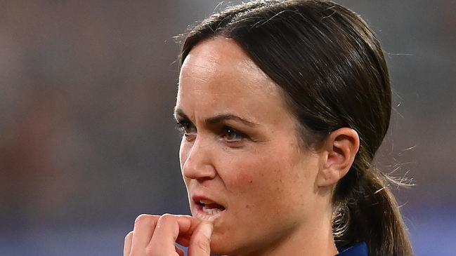 MELBOURNE, AUSTRALIA - MARCH 17: Daisy Pearce looks on as Cats head coach Chris Scott  speaks to his players  during the round one AFL match between Geelong Cats and Collingwood Magpies at Melbourne Cricket Ground, on March 17, 2023, in Melbourne, Australia. (Photo by Quinn Rooney/Getty Images)