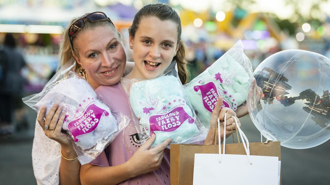 Amanda Smith and daughter April Coles with fairy floss from sideshow alley at the Toowoomba Royal Show, Thursday, March 30, 2023. Picture: Kevin Farmer