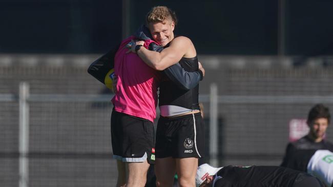 Adam Treloar hugs Nathan Buckley during his time at Collingwood. Picture: Michael Dodge