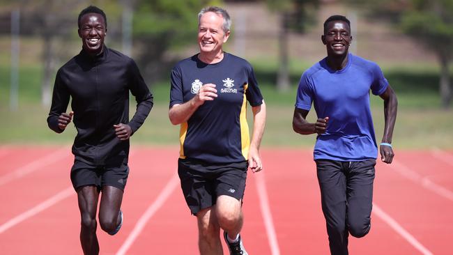 Australia 800m record holder Joseph Deng (left) and training partner Peter Bol with Opposition Leader Bill Shorten in Melbourne. Picture: Alex Coppel