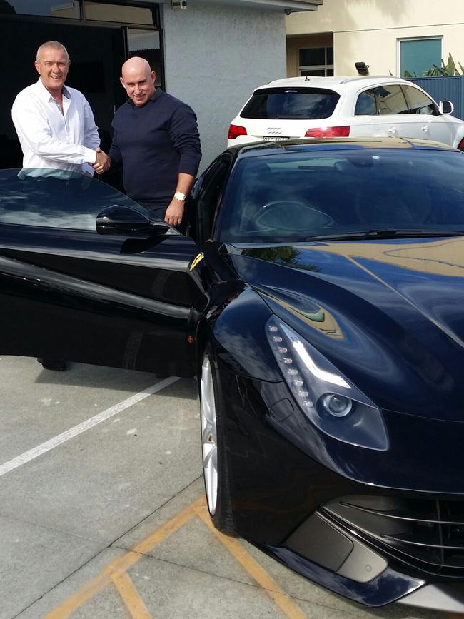 Don Carlson hands keys a $630,000 Ferrari F12, to Michael Irwin in 2015.