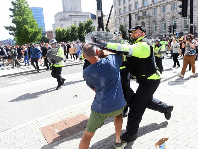 Police officers try to restrain a protester in Liverpool on August 3, 2024 during the 'Enough is Enough' demonstration held in reaction to the fatal stabbings in Southport on July 29. Picture: AFP.