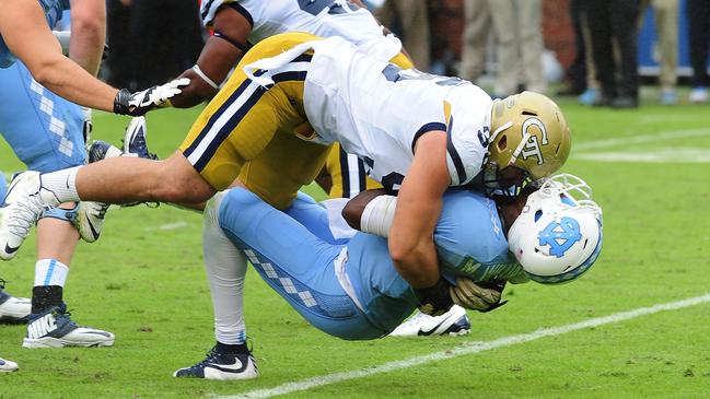ATLANTA, GA - OCTOBER 3: Marquise Williams #12 of the North Carolina Tar Heels takes a hit from Adam Gotsis #96 of the Georgia Tech Yellow Jackets on October 3, 2015 in Atlanta, Georgia. Gotsis would be penalized and ejected from the game for the hit. Photo by Scott Cunningham/Getty Images)