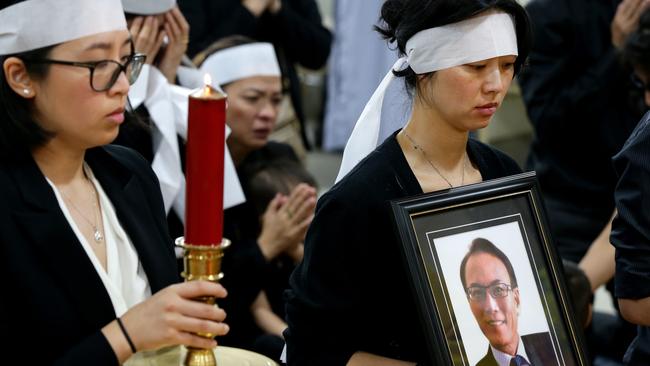 Children Carolyn Le Dinh and Bach Le Dinh during the funeral service for lawyer Ho Ledinh. Picture: Jonathan Ng