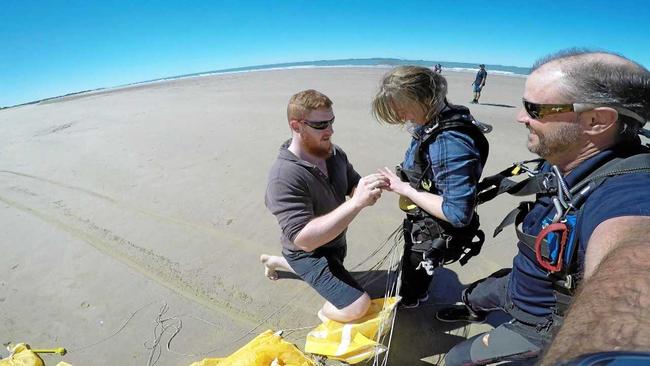 Dean gets on   knee to propose to   Natasha   at Farnborough Beach . Picture: Contributed