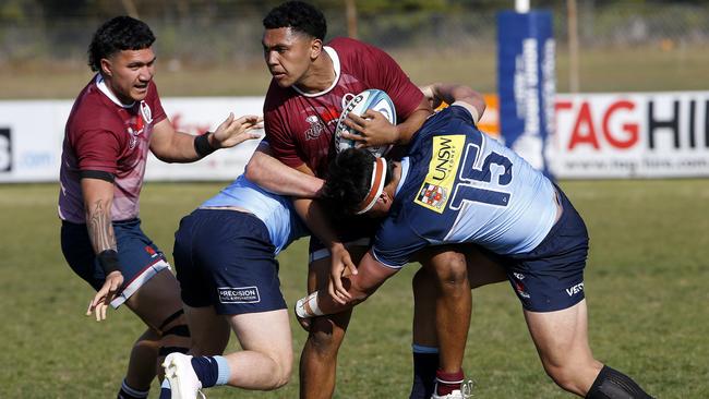 QLD Reds' Amare Milford tackled by Waratahs' Tom Klem and Boston Fakafanua in an under 18s battle. Reds. Picture: John Appleyard