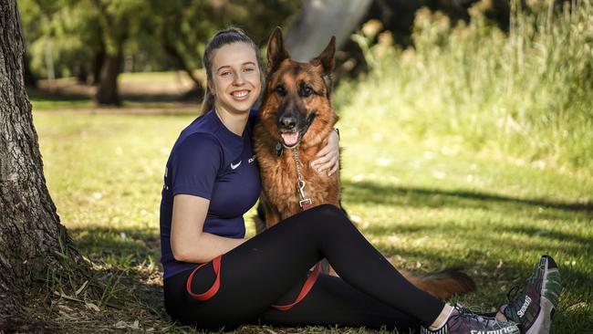 Alex Haydon, pictured with her dog Ace, has starred in squash’s junior ranks for several years. Picture: AAP/Mike Burton