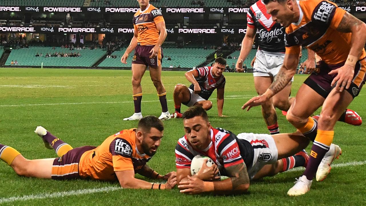 Matthew Ikuvalu of the Roosters scores the opening try in the win over the Broncos