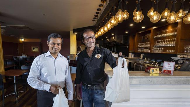 Paradise Biryani House owners Raja Pokala (L) and Suren Gadheraju (R), opened for just two months before they were hit with the latest coronavirus pandemic measures yet they are still working at full steam preparing free lunches for nurses and the community’s most vulnerable. Picture: Matthew Vasilescu