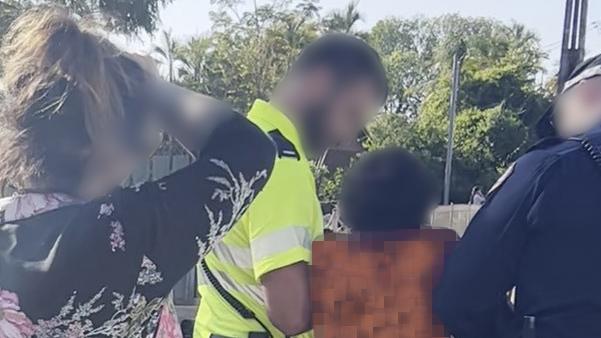 Eleven-year-old Benny struggles with Northern Territory police before being dragged into a paddy wagon on Friday.