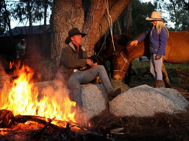 Powell takes a break with daughter Jess on their property east of Cooma.