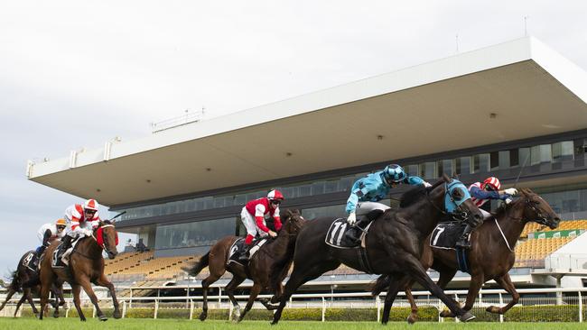 Jake Bayliss rides Okeechobee to victory at Doomben Racecourse in front of empty stands.