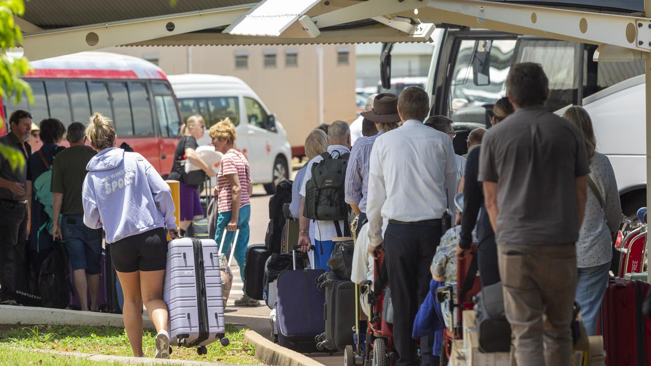 The Ghan holiday makers land via plane at the Darwin Airport after an unexpected end to their scenic train getaway. Picture: Floss Adams.