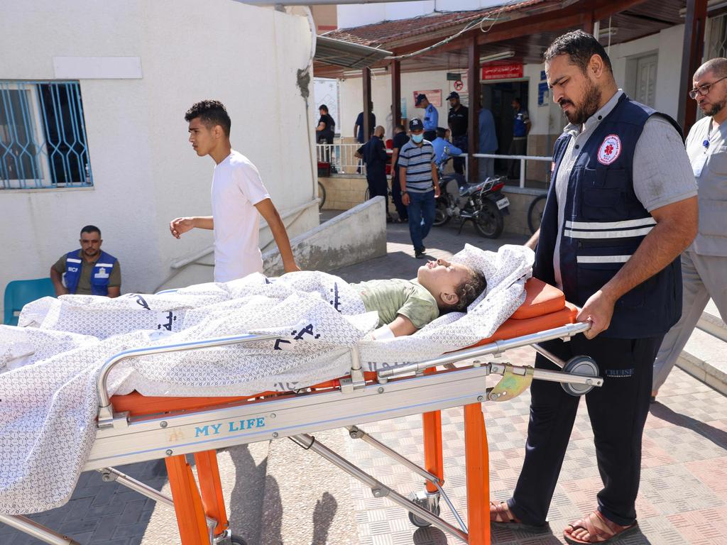 A Palestinian child, injured during an Israeli air strike, is wheeled into a hospital in Rafah, on the southern Gaza Strip. Picture: AFP