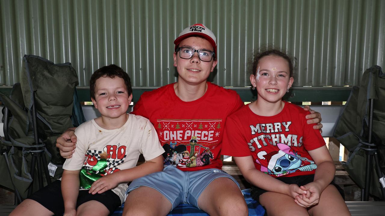 Josh Woodman, 6, Zachary Woodman, 12, and Charlotte Woodman, 9, at the Cairns Churches Joy to the World Community Carols, held at the Cairns Showgrounds. Picture: Brendan Radke