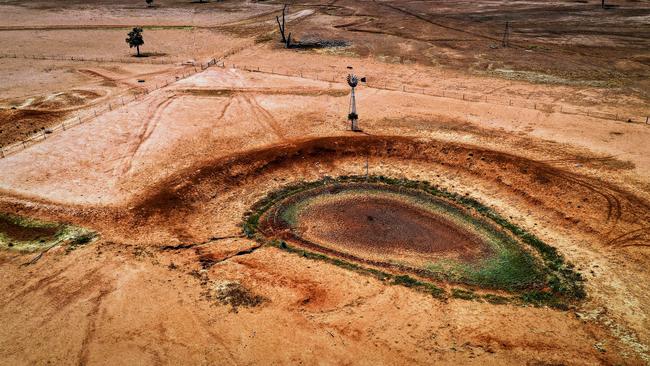 A windmill stands next to a dried-up dam on Australian farmer Ash Whitney's drought-affected property located in the Goolhi area on the outskirts of the northwestern New South Wales town of Gunnedah