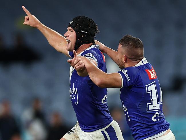 SYDNEY, AUSTRALIA - APRIL 02: Matt Burton of the Bulldogs celebrates kicking the winning field goal with Josh Reynolds of the Bulldogs in extra time during the round five NRL match between Canterbury Bulldogs and North Queensland Cowboys at Accor Stadium on April 02, 2023 in Sydney, Australia. (Photo by Cameron Spencer/Getty Images)