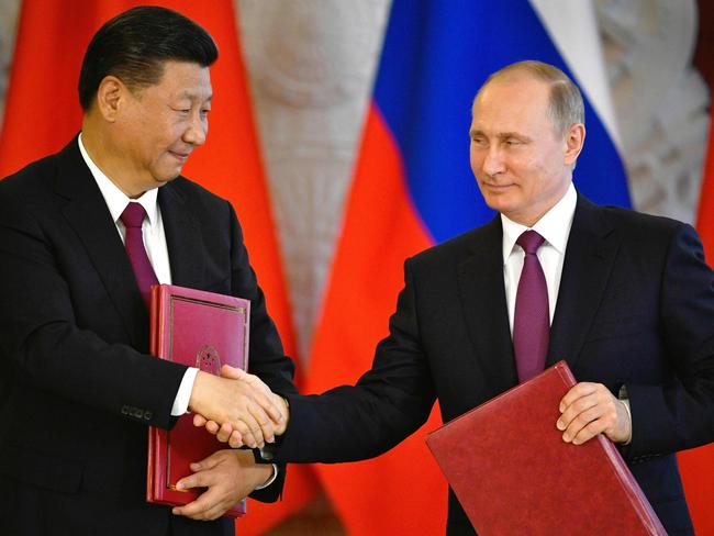 Russian President Vladimir Putin (R) and his Chinese counterpart Xi Jinping shake hands during a signing ceremony in the Kremlin in Moscow on July 4, 2017 The two leader hold formal talks against a backdrop of mounting tensions over North Korea ahead of G20 summit talks with Donald Trump. / AFP PHOTO / Alexander NEMENOV