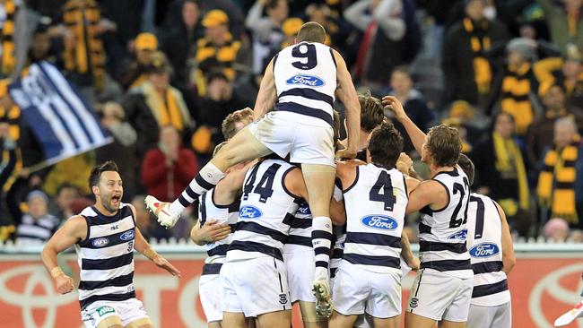 Tom Hawkins is swamped by teammates after his goal after the siren in 2012 against the Hawks. Picture: AAP Image/David Crosling