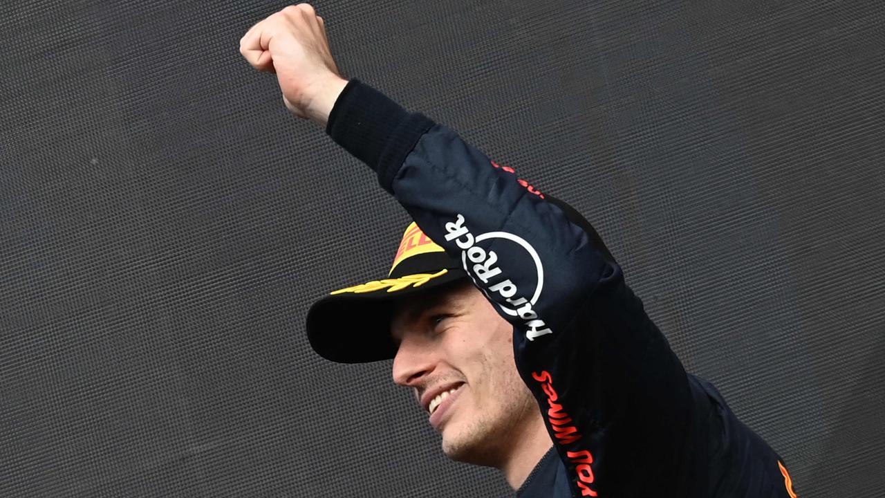 TOPSHOT - Red Bull Racing's Dutch driver Max Verstappen celebrates his victory during the podium ceremony of the Belgian Formula One Grand Prix at Spa-Francophones racetrack at Spa, on August 28, 2022. (Photo by JOHN THYS / AFP)