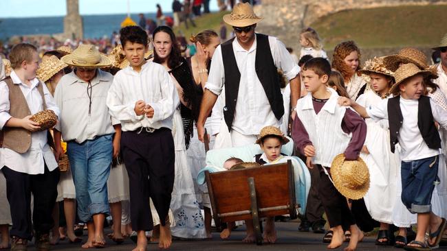 Pitcairn families dressed in local costume march from the wharf at Kingston to the cemetery during Bounty Day on Norfolk Island in 2004.