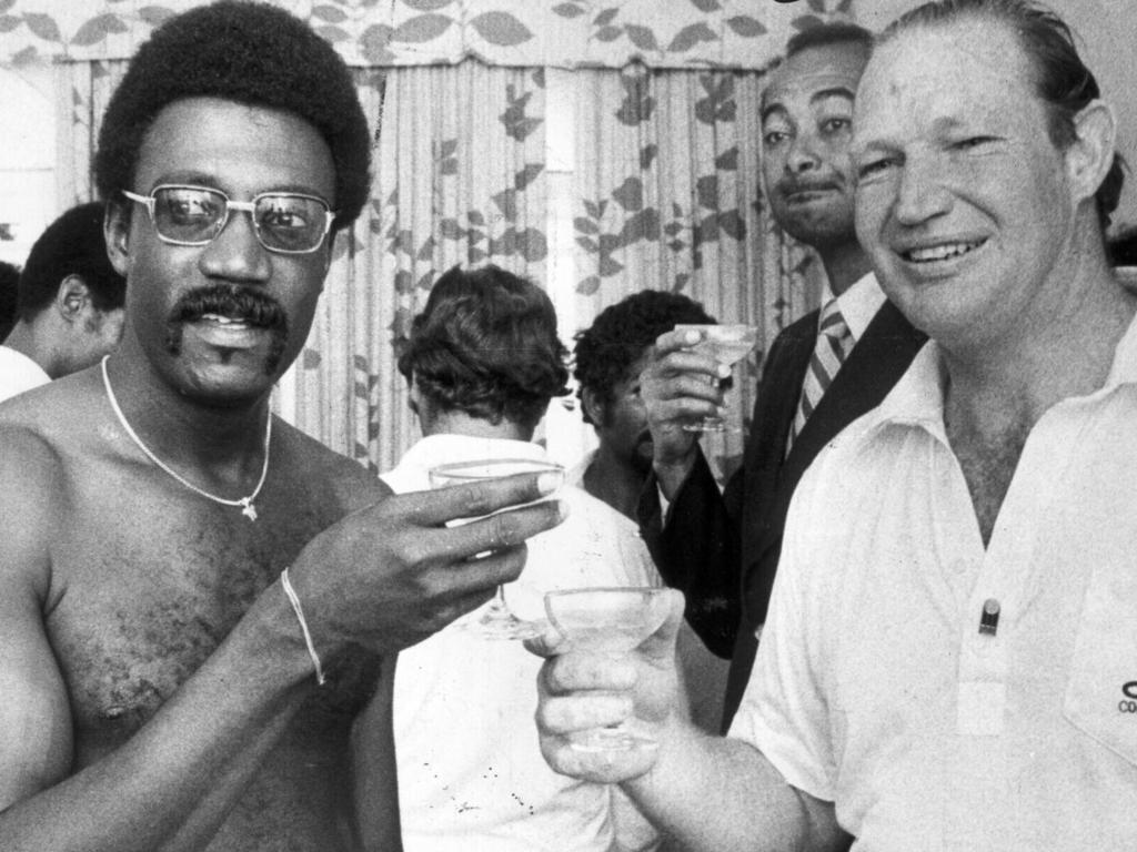 Kerry Packer drinking champagne with West Indies' cricketer Clive Lloyd.