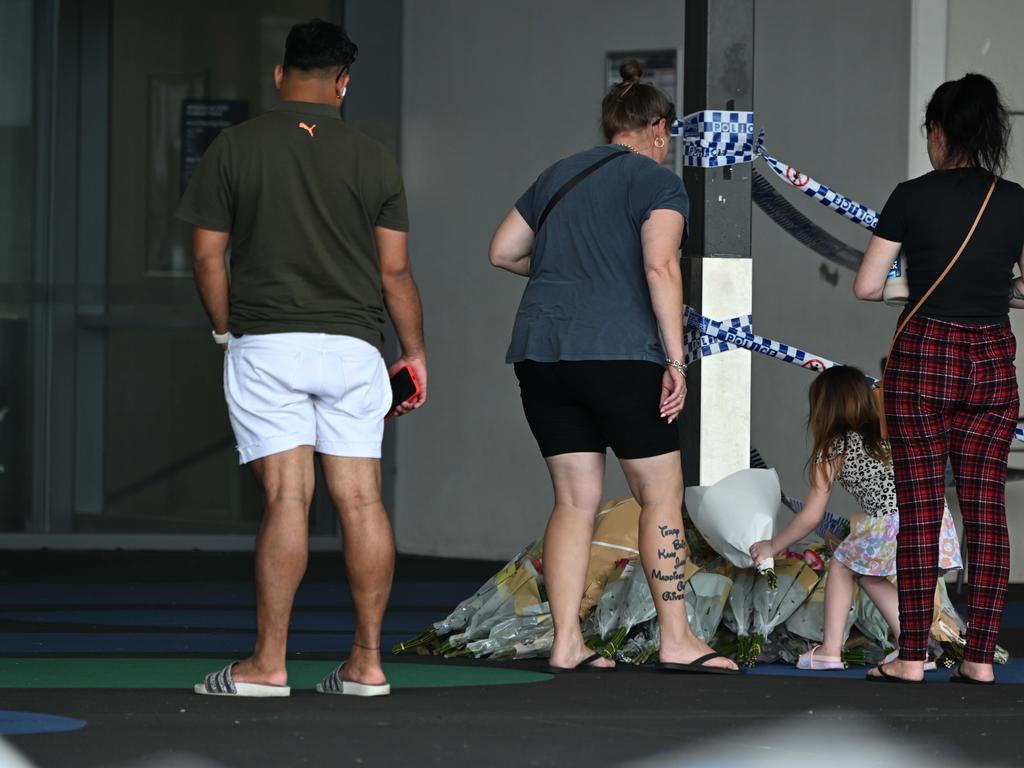 People lay flowers in tribute to Vyleen White. Picture: Lyndon Mechielsen/Courier Mail