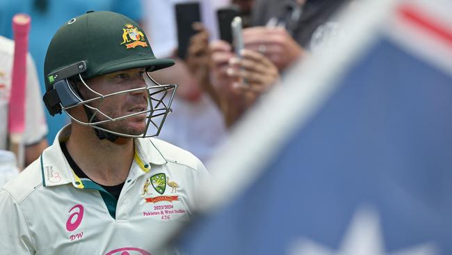 Australia's David Warner walks out to bat during his 112th and final Test on day four of the third cricket Test match between Australia and Pakistan at the Sydney Cricket Ground in Sydney on January 6, 2024. (Photo by Saeed KHAN / AFP) / -- IMAGE RESTRICTED TO EDITORIAL USE - STRICTLY NO COMMERCIAL USE --