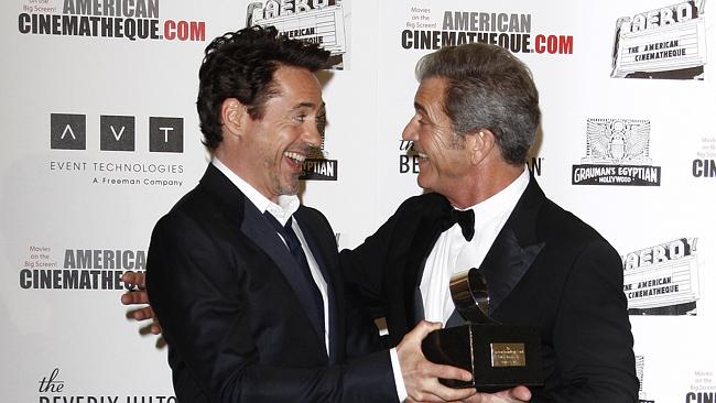 Mel Gibson hams it up with his mate Robert Downey Jr at the American Cinematheque Award Ceremony in 2011.