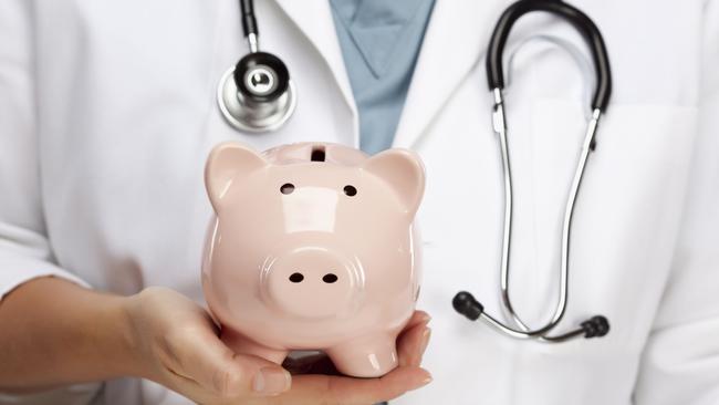 Doctor with Stethoscope Holding Piggy Bank Abstract