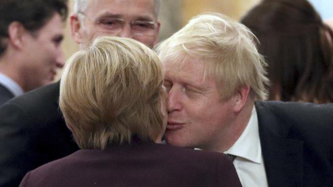 Britain's Prime Minister Boris Johnson greets German Chancellor Angela Merkel during a reception at Buckingham Palace before the NATO summit. Picture: AP