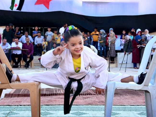 A 6-year-old Syrian girl, Nur Setut, born in 2011 when Syrian civil war began, exercises karate with her own means in Aleppo, Syria on August 09, 2017. Despite all difficulties, her father and mother who are trainers, train their girl to realize her dreams of becoming a world karate champion. (icture: Yehya Alrejjo/Anadolu Agency/Getty Images