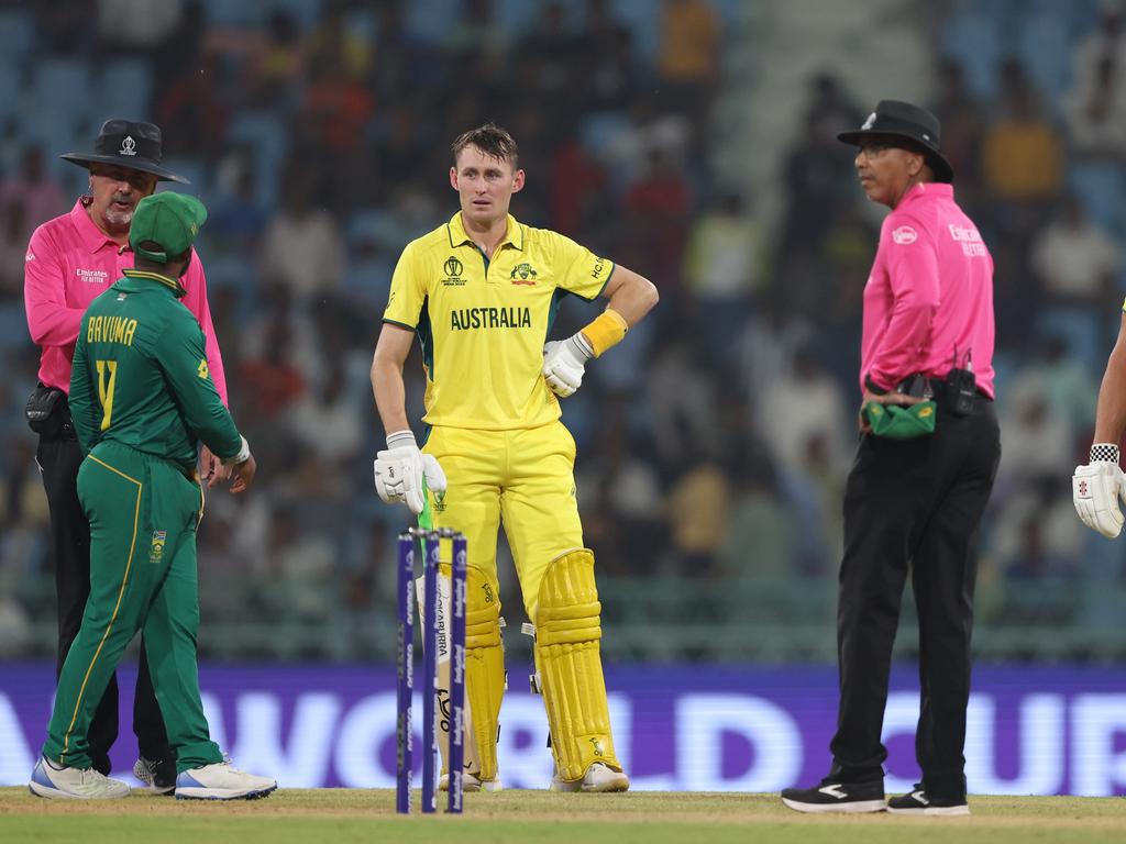 LUCKNOW, INDIA - OCTOBER 12: Marcus Stoinis and Marnus Labuschagne of Australia interacts with Temba Bavuma of South Africa and Match Umpires Richard Illingworth and Joel Wilson after being dismissed from a review during the ICC Men's Cricket World Cup India 2023 between Australia and South Africa at BRSABVE Cricket Stadium on October 12, 2023 in Lucknow, India. (Photo by Robert Cianflone/Getty Images)